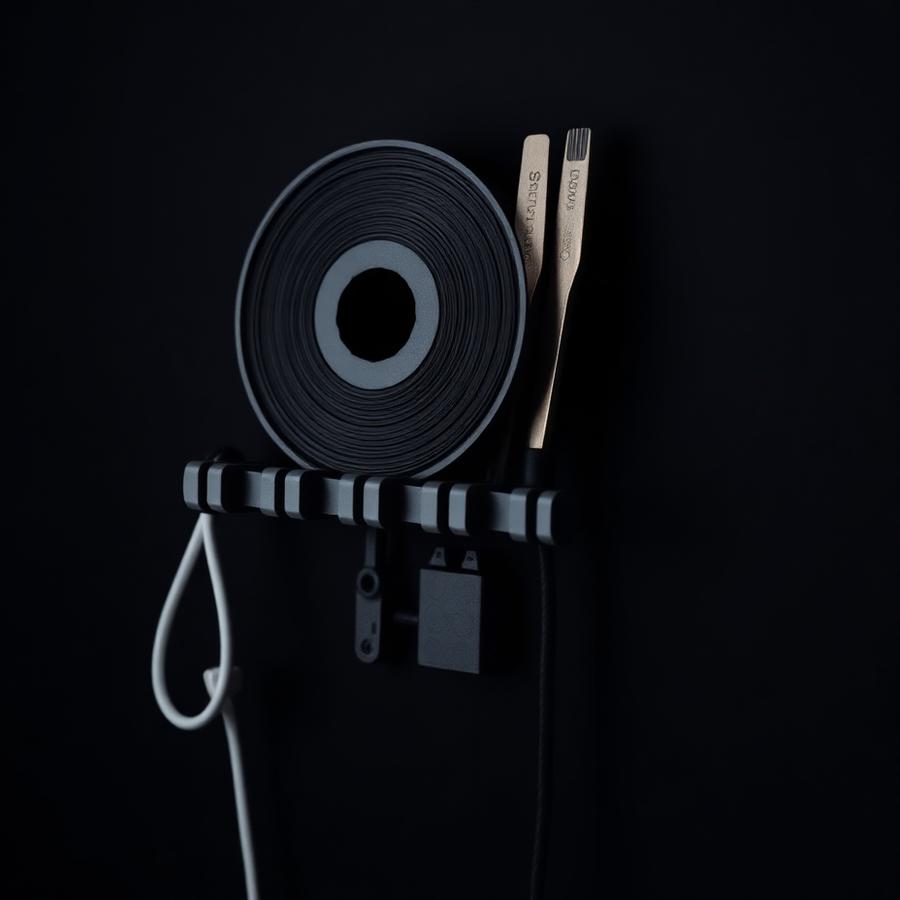 Wall mounted 3D printed rail holding filament and tools